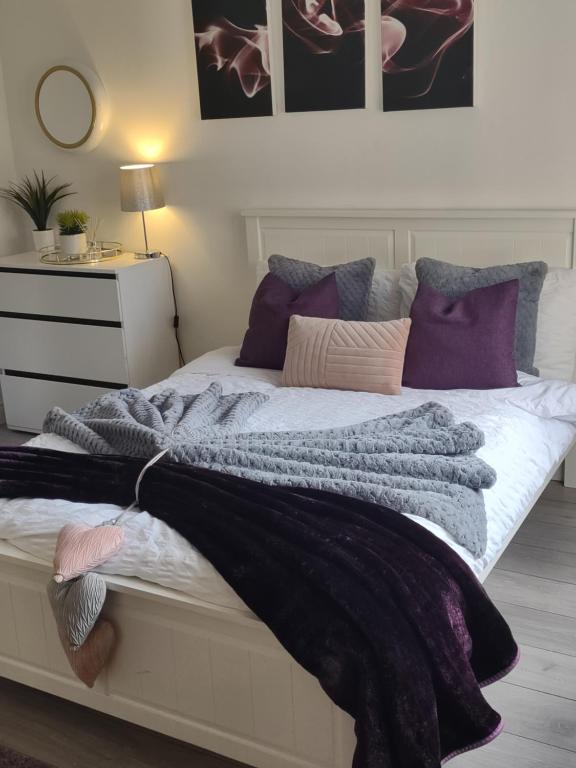 a bedroom with a bed with a blanket on it at De Luxe Aparthotel in Leicester