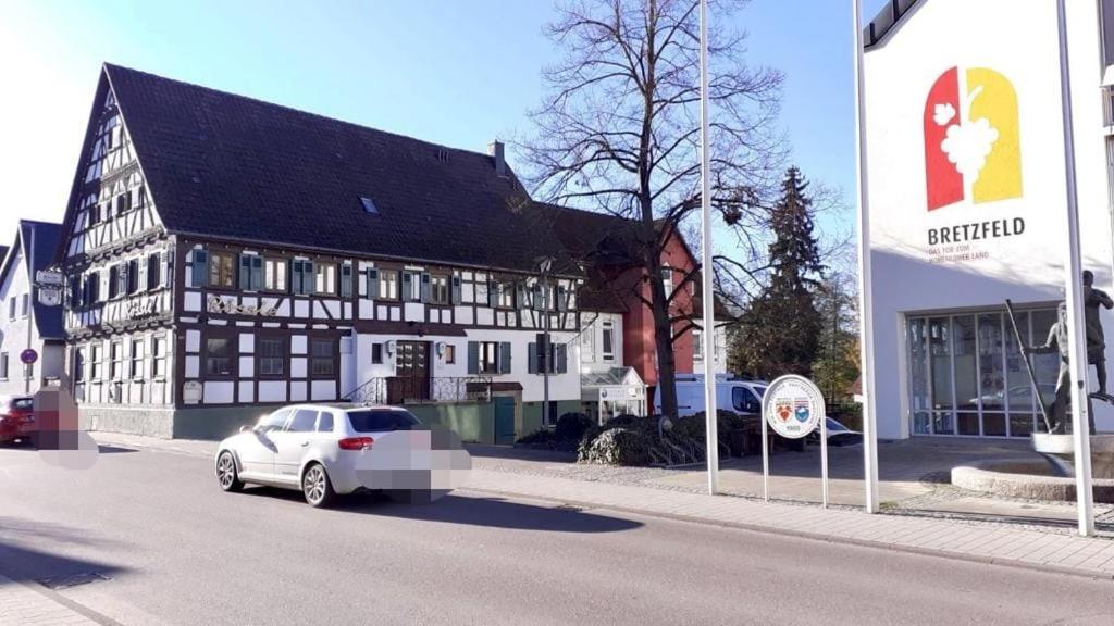 a white car parked in front of a building at Gasthaus Rössle in Bretzfeld
