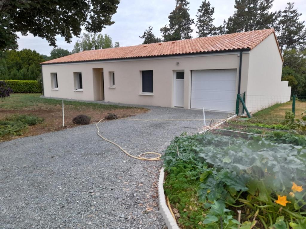 a house with a garden and a driveway at CHEZ VIVIANE in Celles-sur-Belle