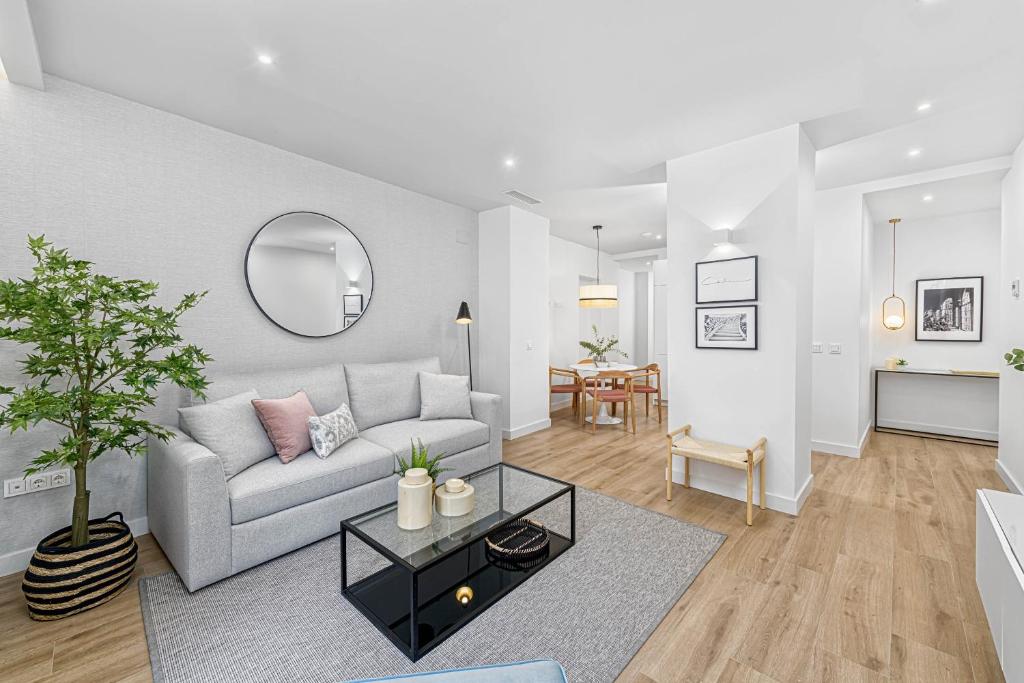 a living room with a couch and a table at iloftmalaga Calle Madre de Dios in Málaga