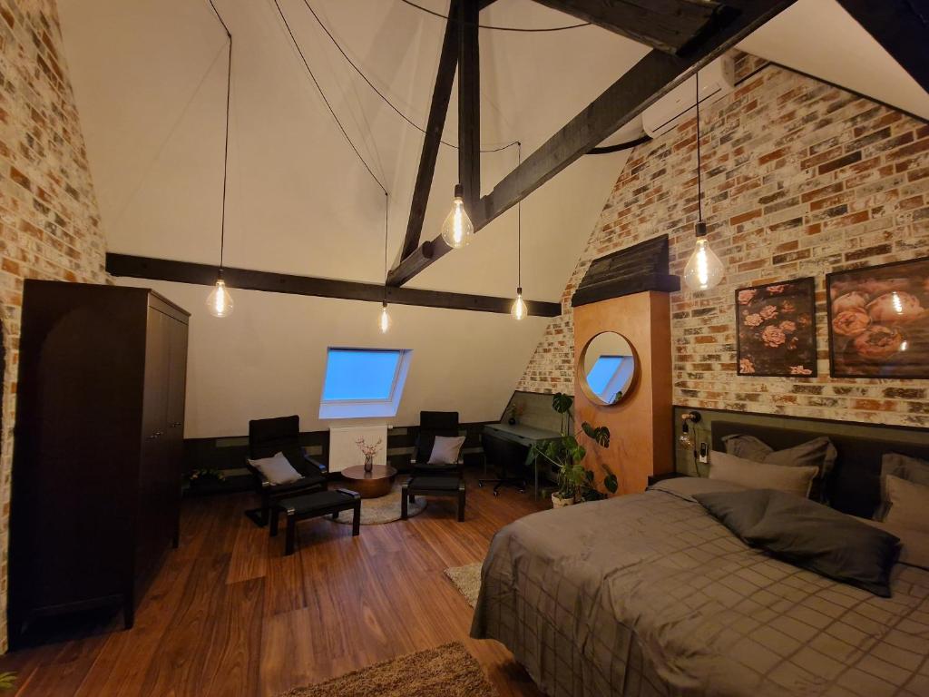 a bedroom with a bed and a desk and chairs at Ferienwohnung Auszeit in Weeze