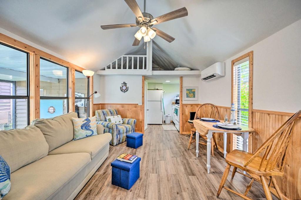 a living room with a couch and a ceiling fan at Everglades City Cabin Dock and Heated Pool! in Everglades City