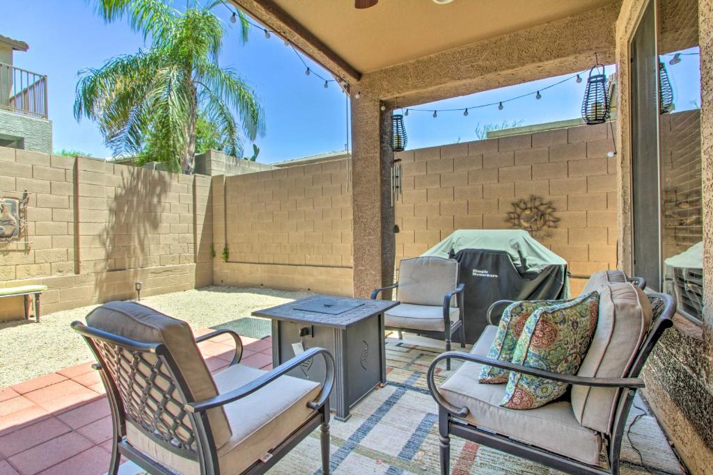 a patio with chairs and a table on a patio at North Phoenix Home with Community Pools! in Anthem