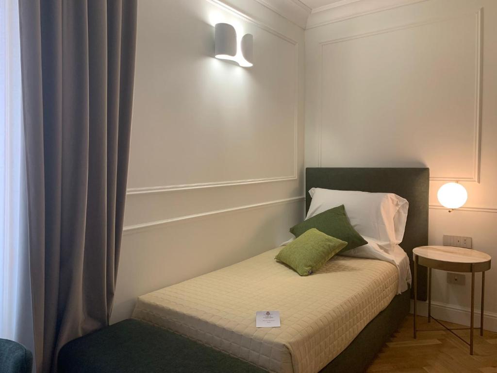 Postel nebo postele na pokoji v ubytování Palazzo Franceschini