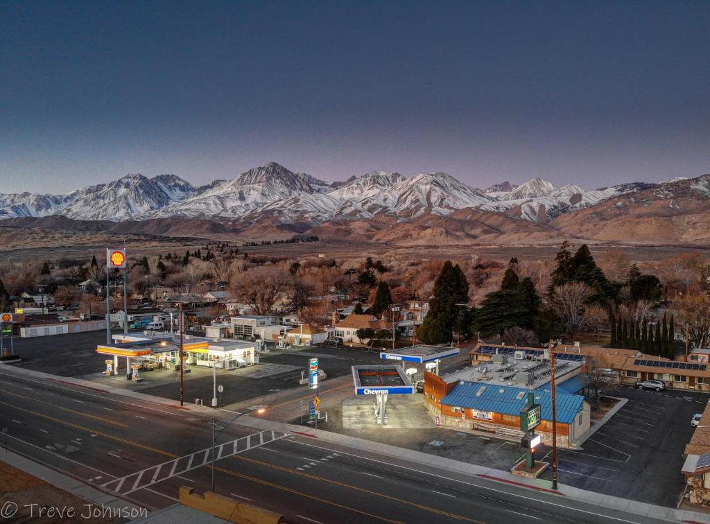 a view of a town with snow capped mountains in the background at Bristlecone Motel in Big Pine