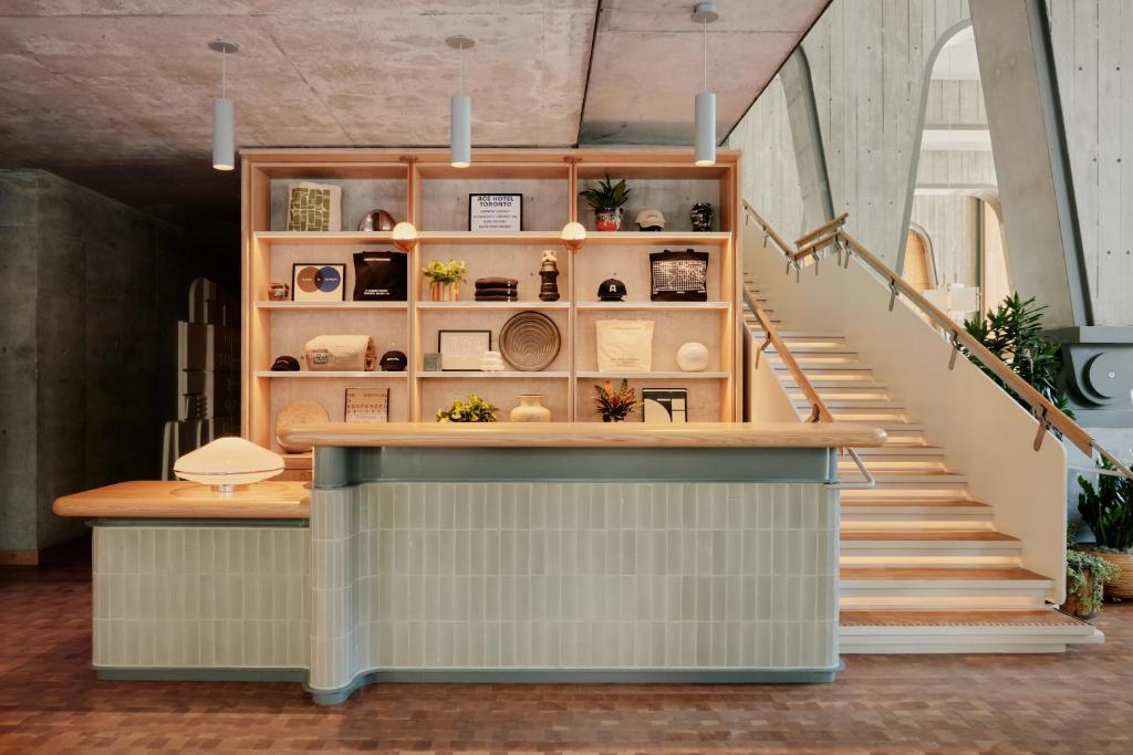 a staircase leading up to a store with a counter and stairs at Ace Hotel Toronto in Toronto