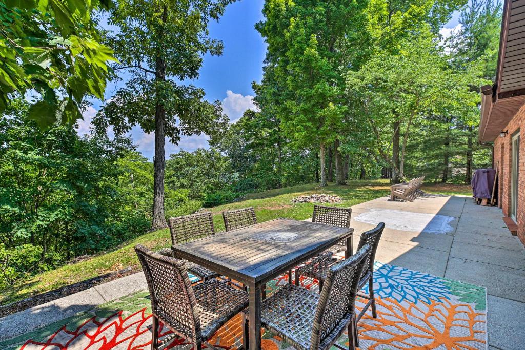 a patio with a table and chairs on a sidewalk at Idyllic Bronston Retreat with Fire Pit and View! in Burnside