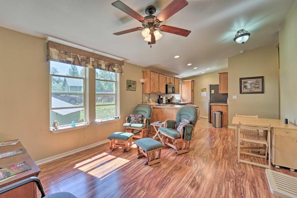 a living room with a ceiling fan and a kitchen at Secluded Durango Cabin about 11 Mi to Downtown! in Durango