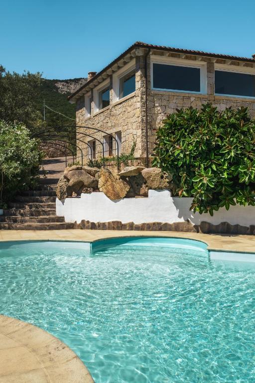 a swimming pool in front of a house at Villa Elicriso in Olbia