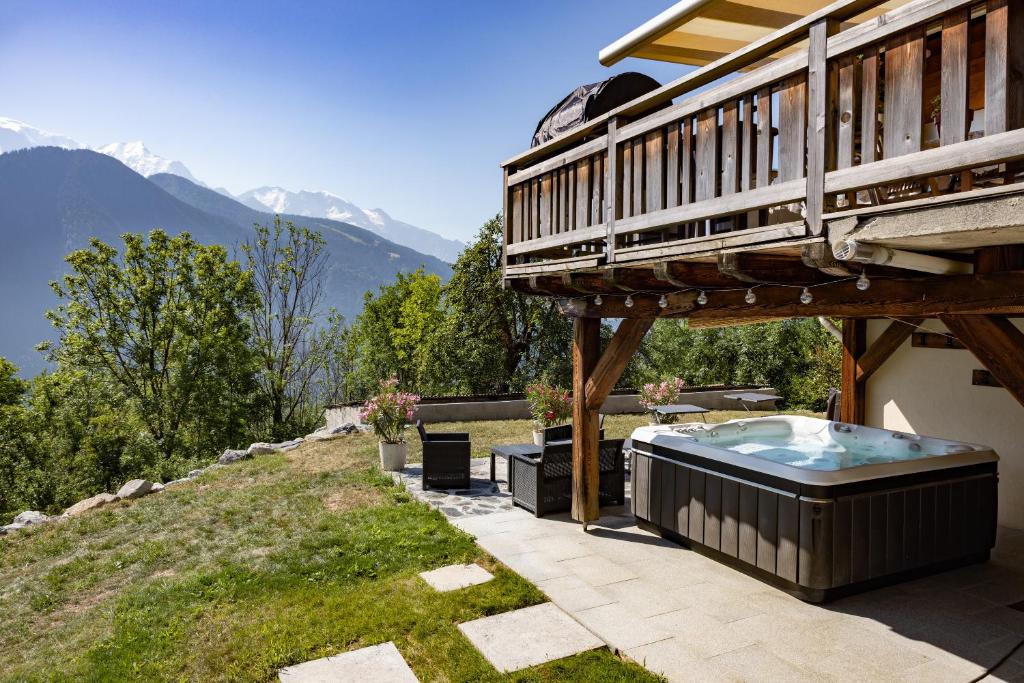 a hot tub on the patio of a house at Chalet les Fiz in Passy