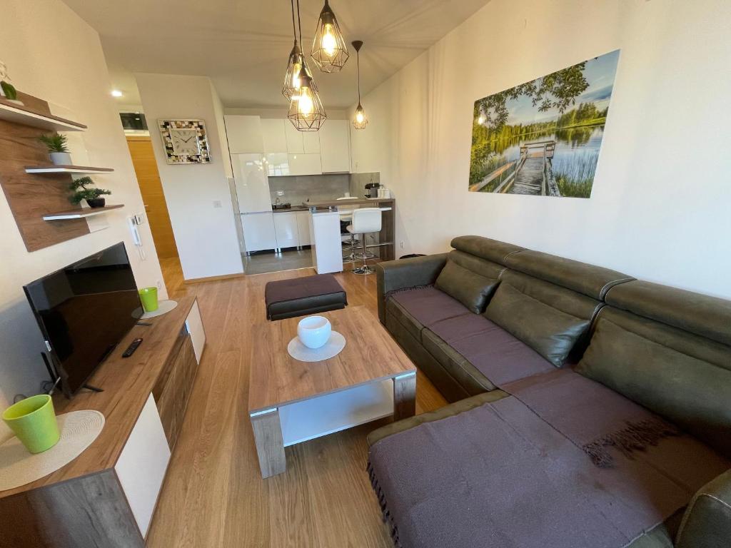 a living room with a couch and a table at Fantastic centar Novi Sad in Novi Sad