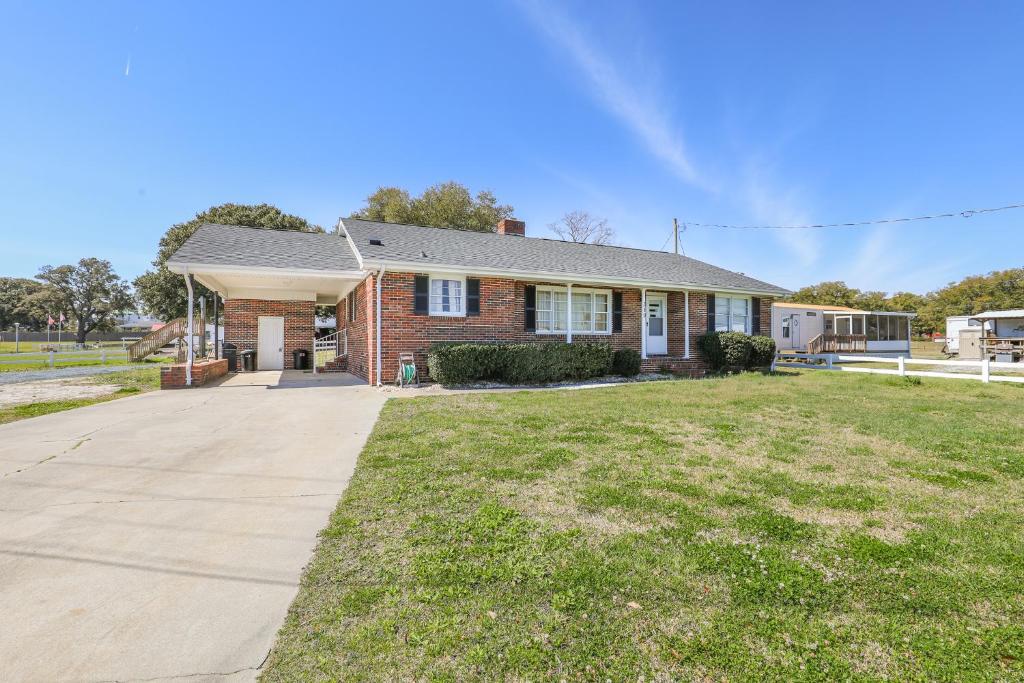 a brick house with a driveway at Spacious Home with Waterfront View-Welcome Pets in Sneads Ferry
