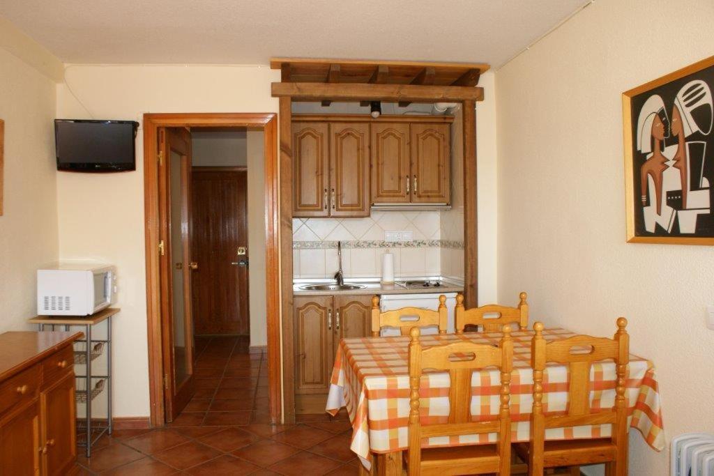 a kitchen with a table and chairs in a room at Estudio con vistas Edificio Bulgaria in Sierra Nevada