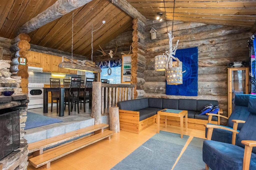 a living room with a couch and a dining room at Pihlakieppi 1 in Ruka