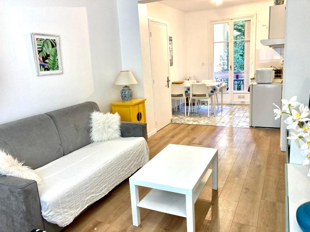 a living room with a couch and a table at Maison otto in Menton