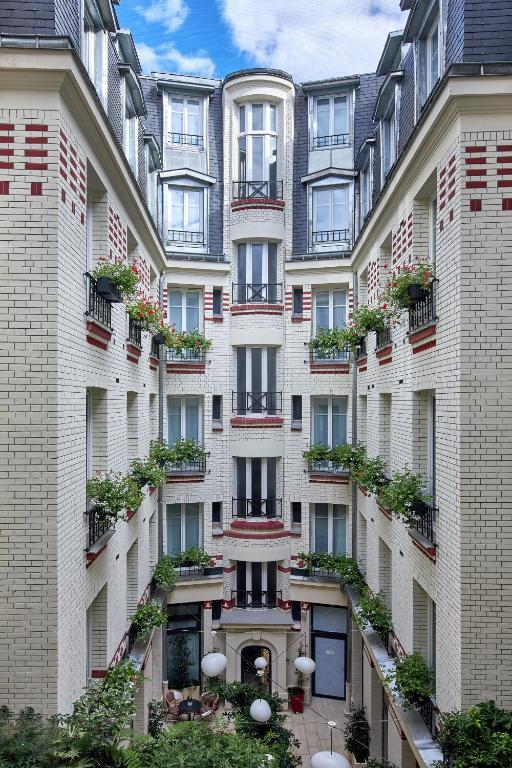 an apartment building with plants on the facade at Hotel Villa Romantic &amp; Spa in Paris