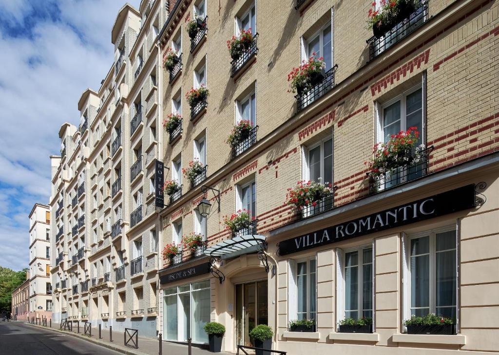 a building with flowerpots on the side of a street at Hotel Villa Romantic &amp; Spa in Paris