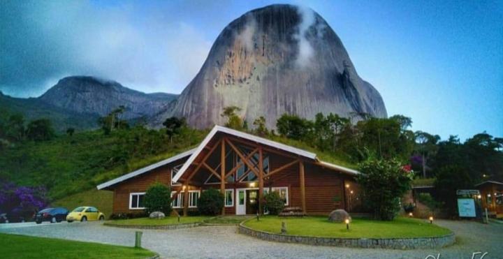 a building with a mountain in the background at LUZ DO LUAR in Pedra Azul