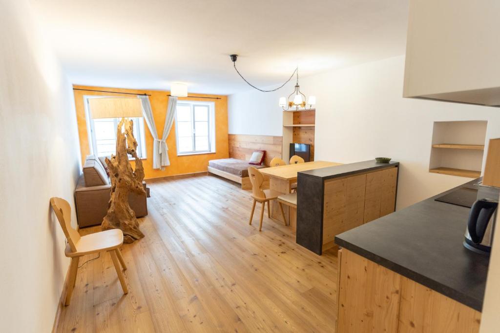 a kitchen and living room with a table and chairs at Agalma in Brunico