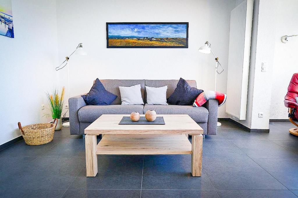 a living room with a couch and a coffee table at Strandhochhaus SD09 in Cuxhaven