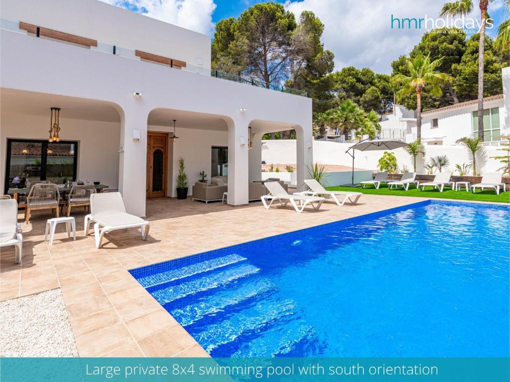 a villa with a swimming pool and a patio at Villa Milana by HMR Holidays in Moraira