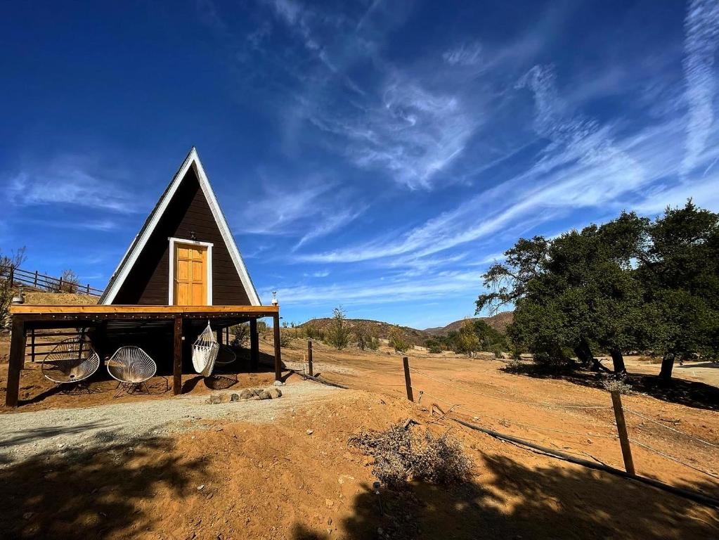 a small house in the middle of a field at Árbol de la Vida Glamping Valle de Guadalupe 