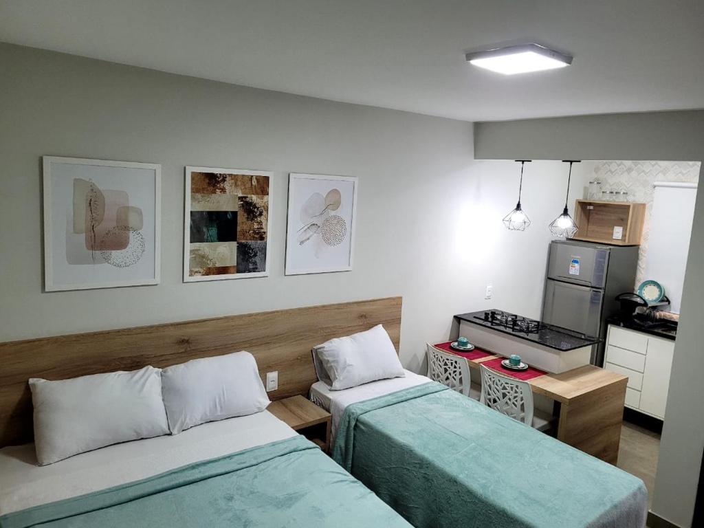Habitación pequeña con 2 camas y cocina en Pousada Solaris, en Salvador