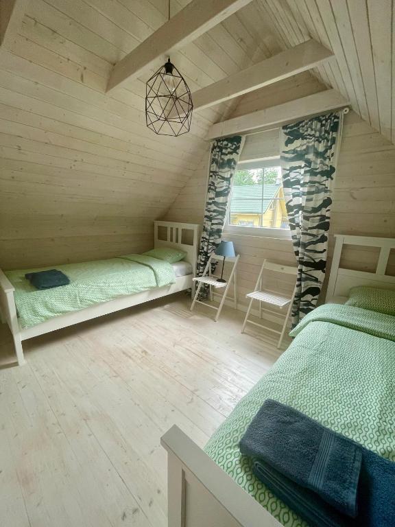 Postel nebo postele na pokoji v ubytování Ustronie Leśne 2
