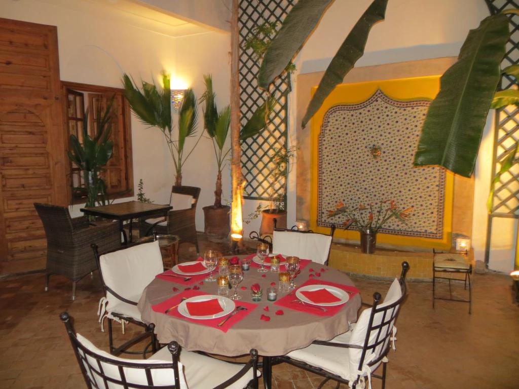 a dining room with a table with a red table cloth at Riad Irene in Marrakech