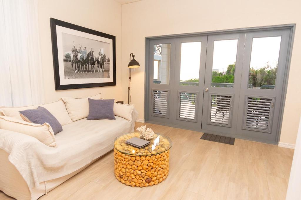 a living room with a white couch and a table at West Rock Villas in Saint James