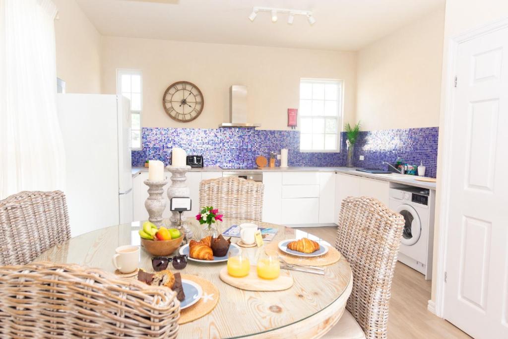 a kitchen with a table with fruit on it at West Rock Villas in Saint James