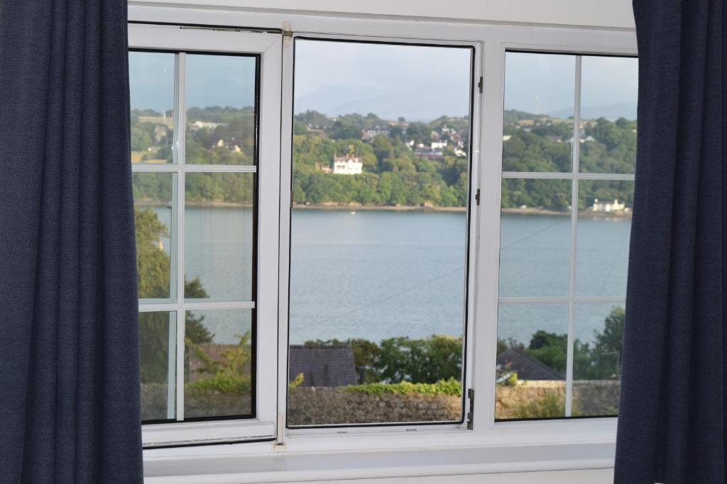 a window with a view of a body of water at Mews Cottage in Menai Bridge