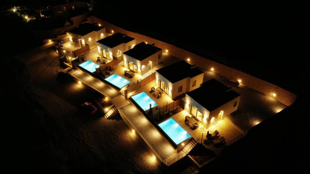 an aerial view of a building with lights at night at Manifesto Suites in Monemvasia