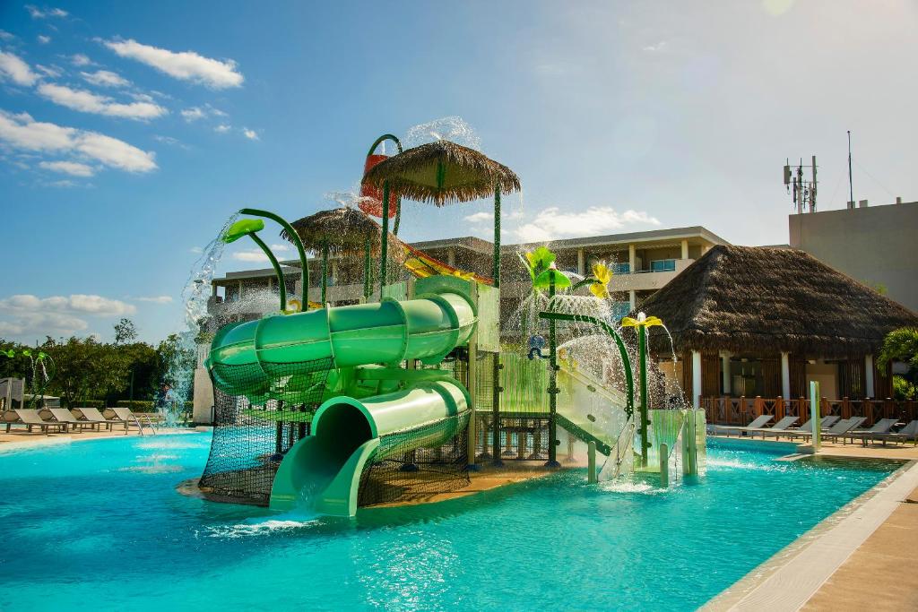 a water slide in the middle of a swimming pool at Paradisus Playa del Carmen - Riviera Maya - All Inclusive in Playa del Carmen