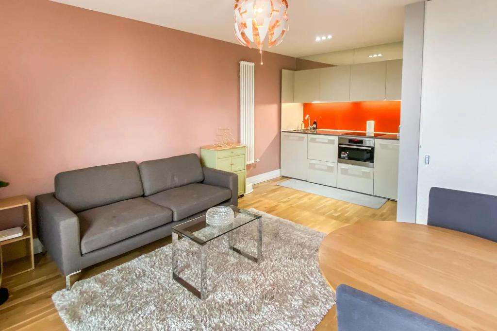 a living room with a couch and a table at Arcus Apartment 33 in Leicester