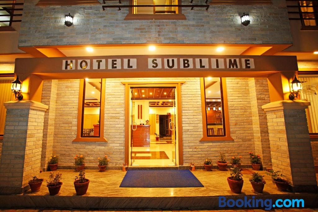 a hotel building with a mat in front of it at Hotel Sublime in Pokhara