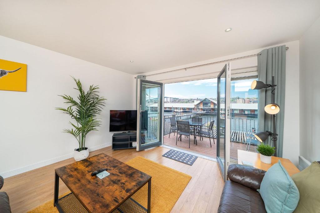 a living room with a couch and a table at Quayside Apartment in Dundee