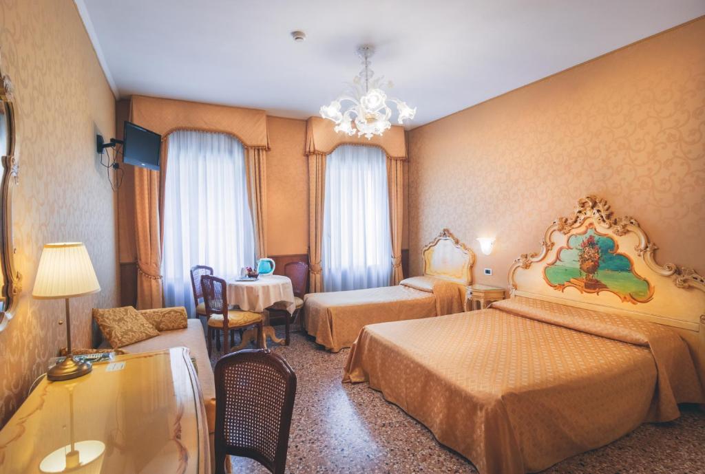 Postel nebo postele na pokoji v ubytování Hotel Al Malcanton