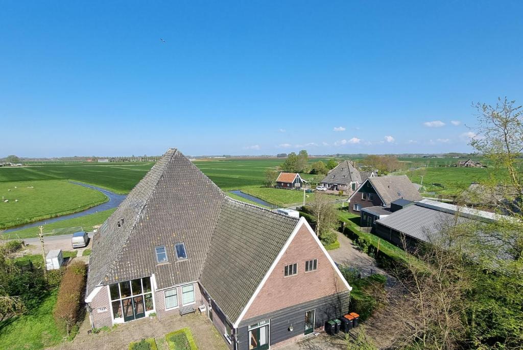 an aerial view of a house with a roof at Bed & Breakfast De Koegang in Zuidermeer