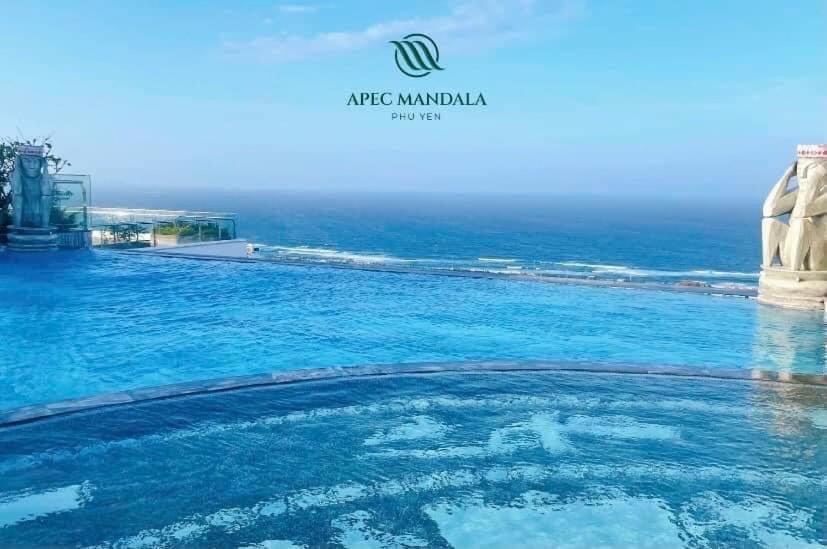 a swimming pool with the ocean in the background at Apec Mandala Tuy Hòa Phú Yên Tina House in Ðông Tác (1)