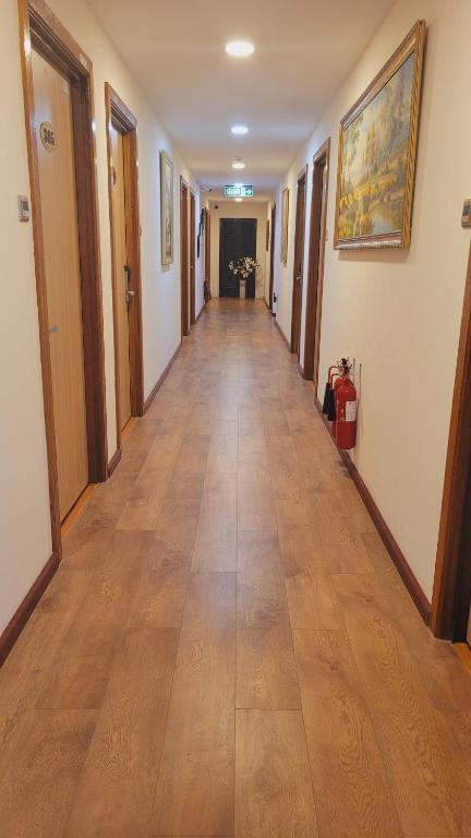 a long hallway with wooden floors in a building at Coconut Bay Lodge - Beribi in Bandar Seri Begawan