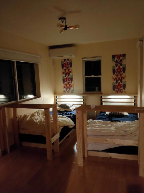 Postel nebo postele na pokoji v ubytování jiro de kamakura