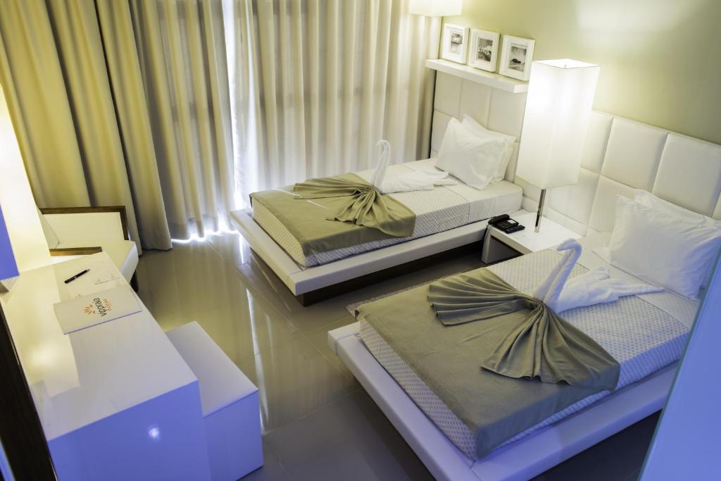 Postel nebo postele na pokoji v ubytování Hotel Vip Praia