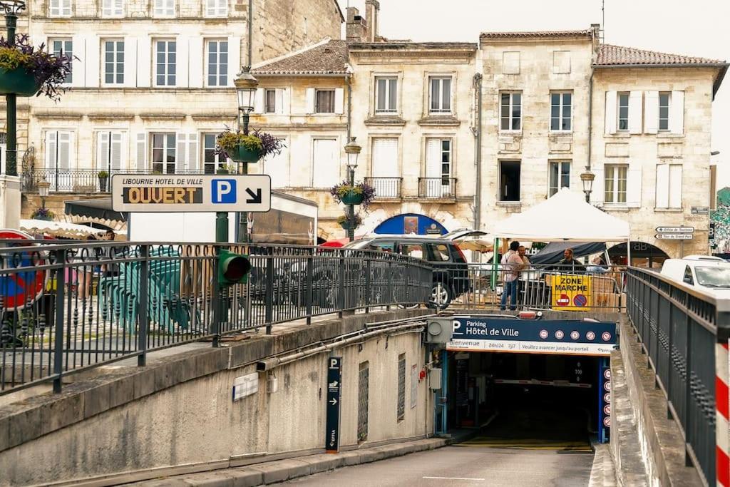 a tunnel in a city with a sign on a bridge at La Cloche Studio Hypercentre Mairie in Libourne
