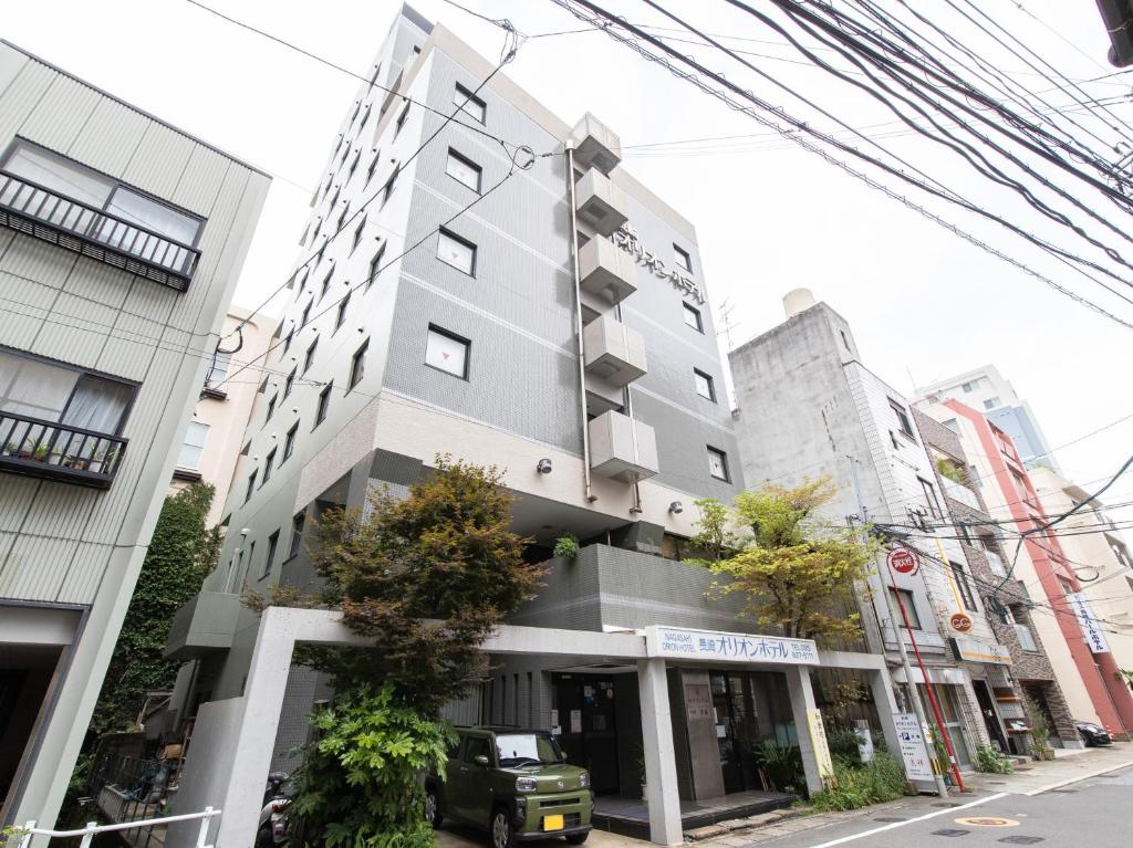 ein hohes Gebäude in einer Stadtstraße in der Unterkunft Nagasaki Orion Hotel in Nagasaki