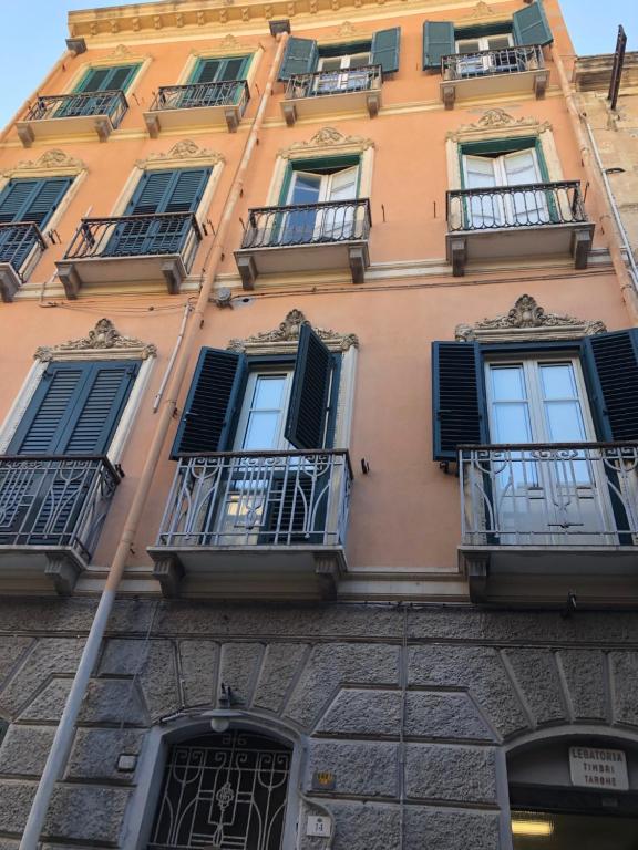 a tall building with windows and balconies on it at Maisonvanilla in Cagliari