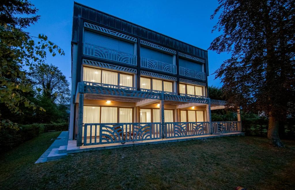 a large house with a balcony on a yard at Villa Mihaela in Bled