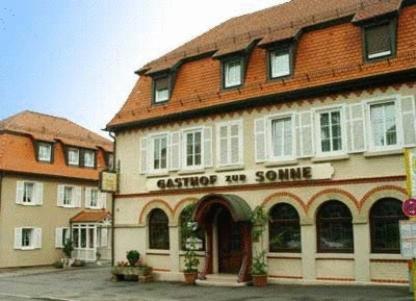 a building with a red roof in a street at Gasthof zur Sonne in Stuttgart