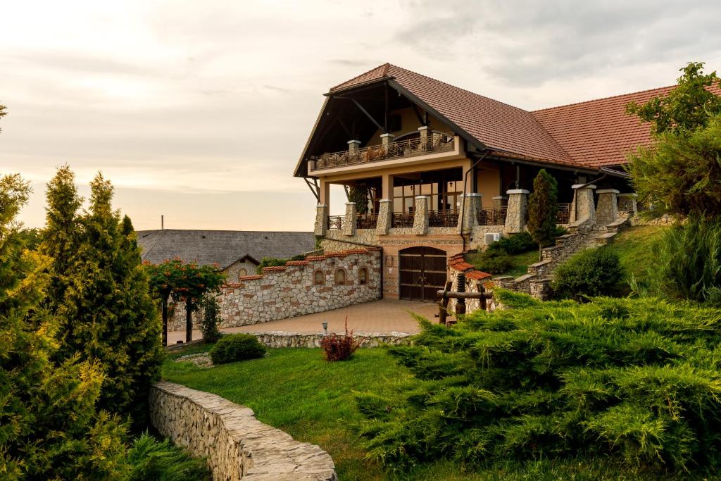 a large house with a stone wall at Chateau Vartely in Orhei