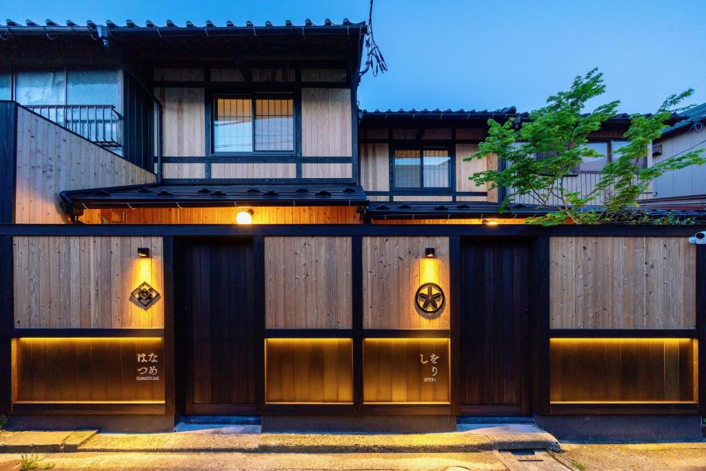 un bâtiment avec deux portes et une clôture dans l'établissement Hanatsume Machiya House, à Kanazawa